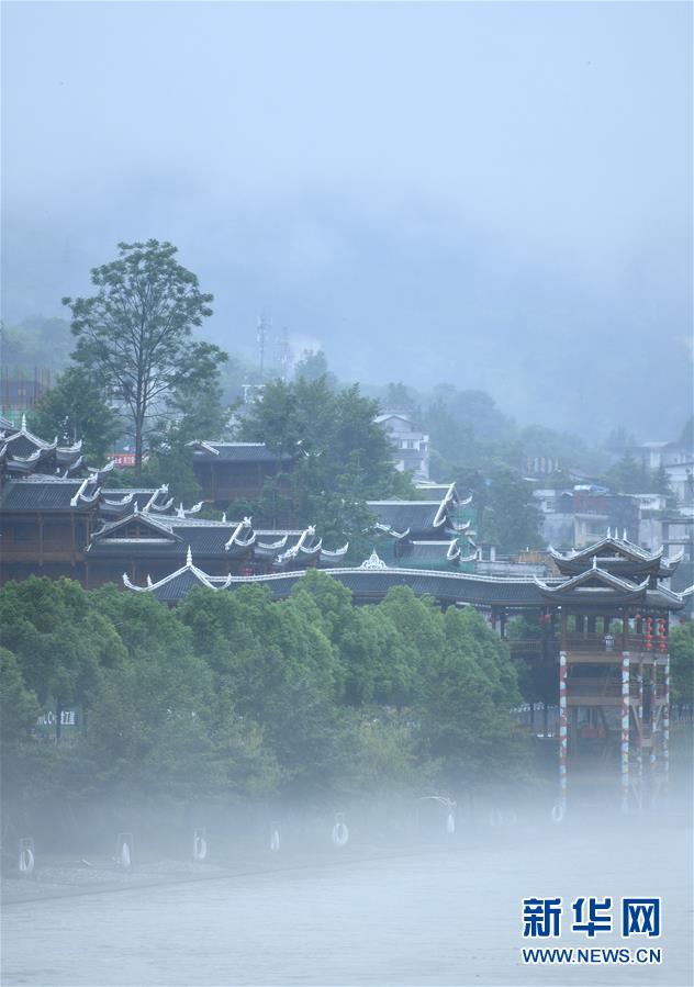 6月23日，一場(chǎng)雨后，湖北省恩施土家族苗族自治州宣恩縣貢水河霧氣升騰，河畔亭臺(tái)樓閣若隱若現(xiàn)，宛若仙境。 新華社發(fā)（宋文 攝）